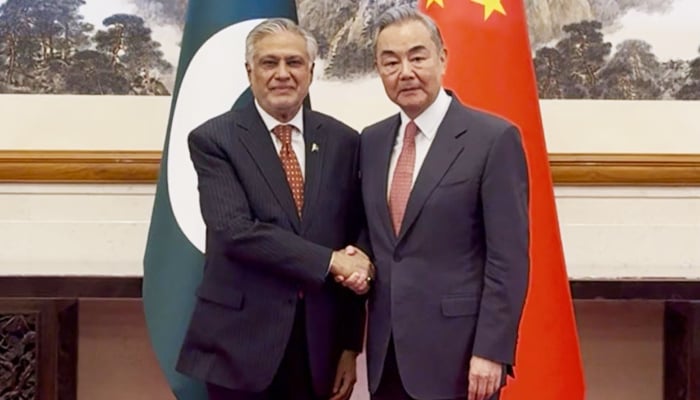 Chinese Foreign Minister Wang Yi (right) greets Deputy Prime Minister and Foreign Minister Ishaq Dar in Beijing on May 20, 2025. — X/@ForeignOfficePK